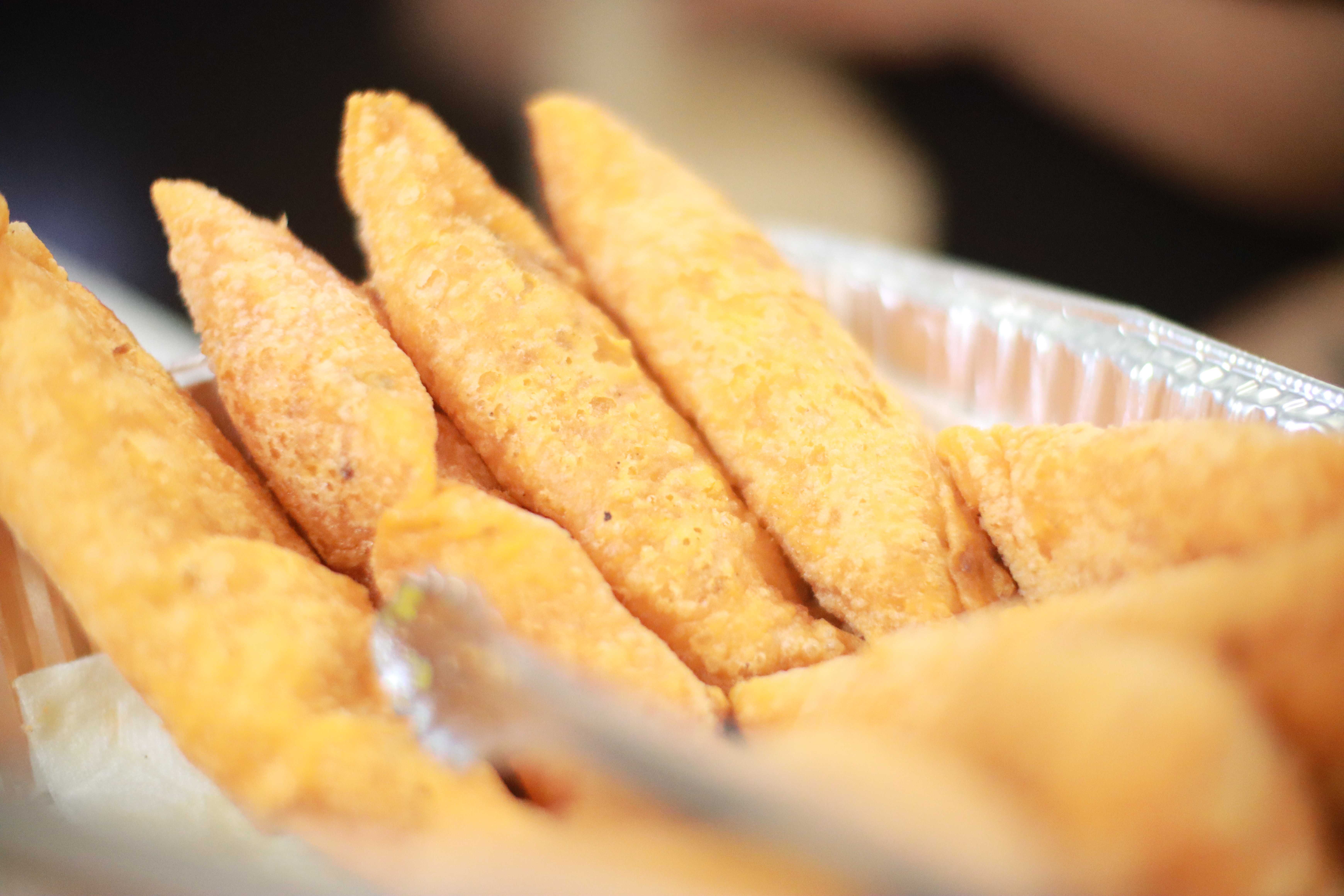 Multiple golden empanadas arranged in tray
